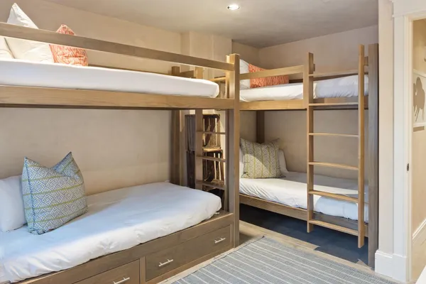 a large bed sitting in a bedroom next to a cabinet
