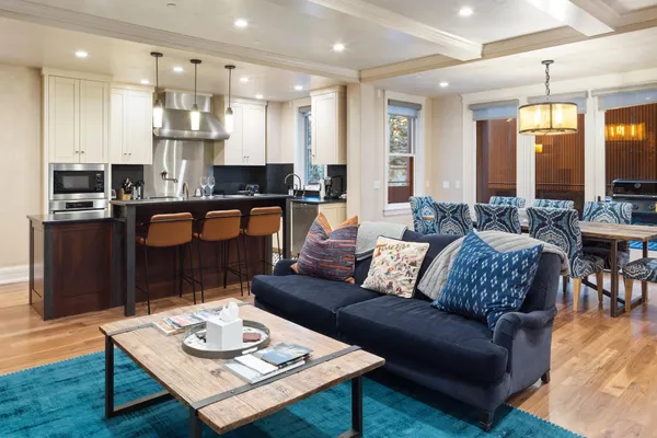 a kitchen with stainless steel appliances granite countertop a sink a stove and a refrigerator