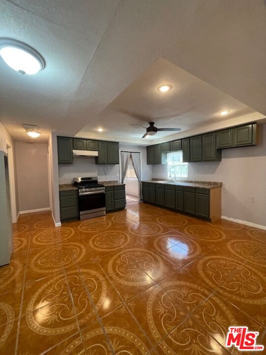 604 Eye Street Bakersfield, CA 93304 - Photo 33 of 33 a large kitchen with stainless steel appliances a large counter top