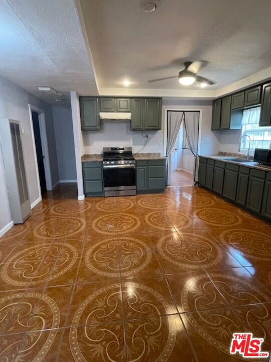 604 Eye Street Bakersfield, CA 93304 - Photo 9 of 33 a kitchen with stainless steel appliances granite countertop a stove a sink and a refrigerator