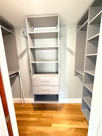 a view of walk in closet with empty racks