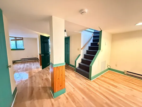 a view of an entryway with wooden floor