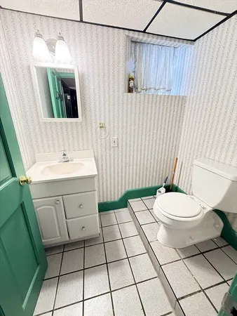 a bathroom with a sink a toilet and mirror