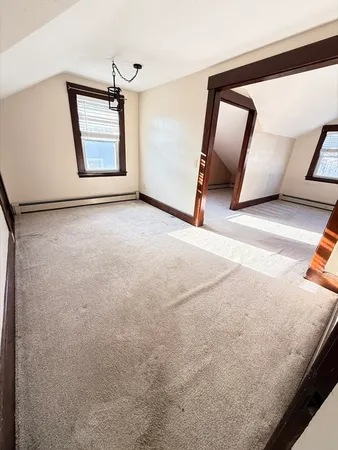 a view of a livingroom with wooden floor and a large window