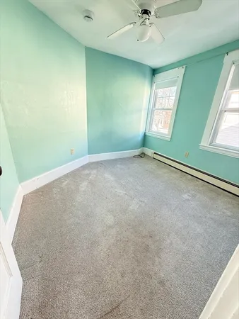 a view of an empty room with windows