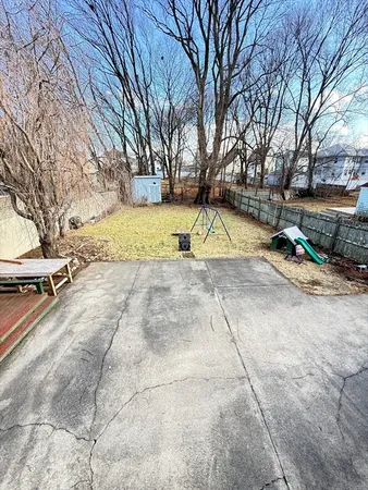 a view of yard with swimming pool and seating area