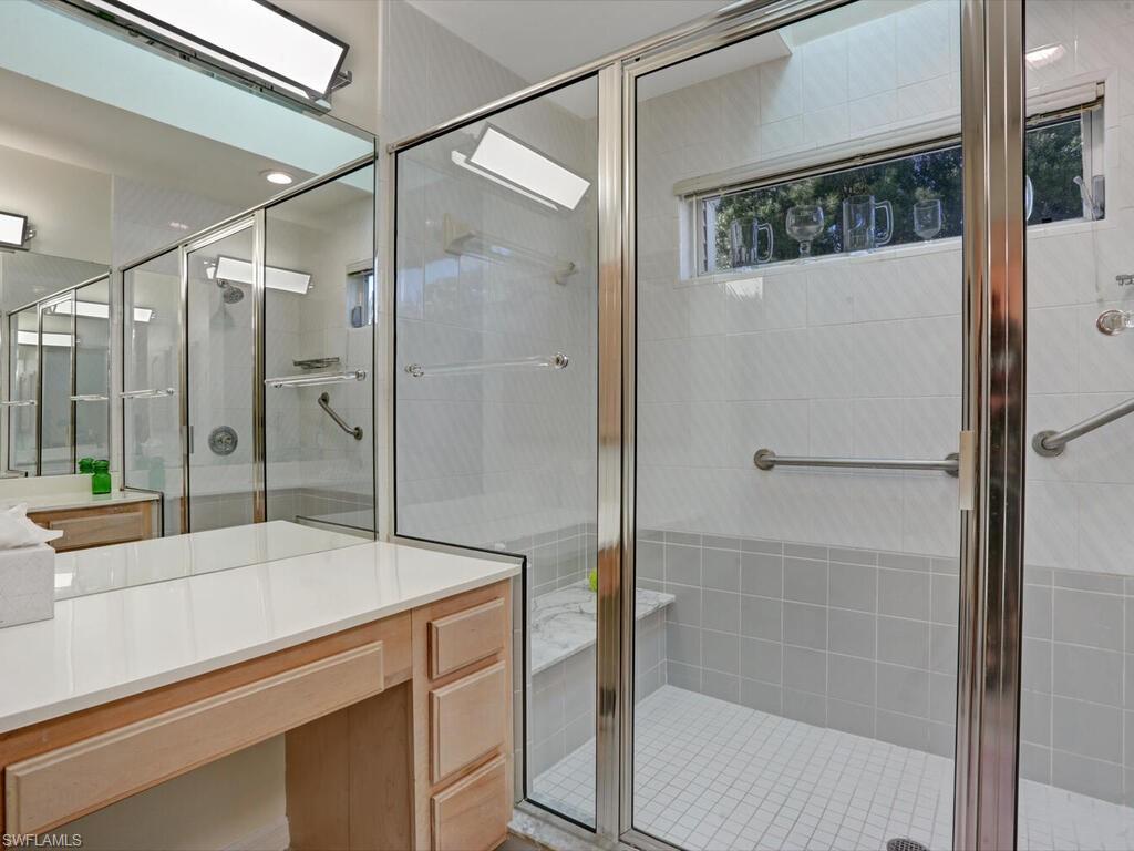 15335 Wimborne Lane Naples, FL 34110 - Photo 24 of 33 a bathroom with a shower and a sink