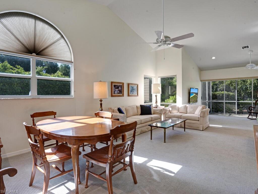 15335 Wimborne Lane Naples, FL 34110 - Photo 6 of 33 a living room with furniture a window and a chandelier