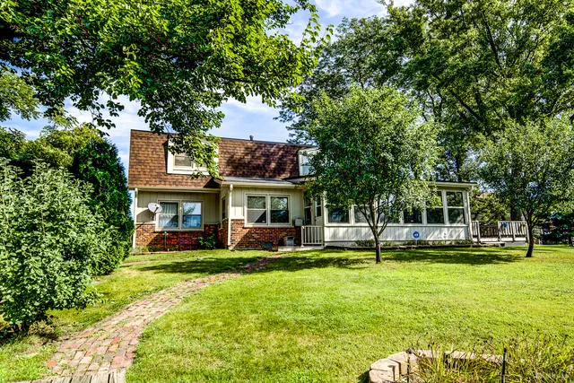 a view of a building with a yard porch and sitting area