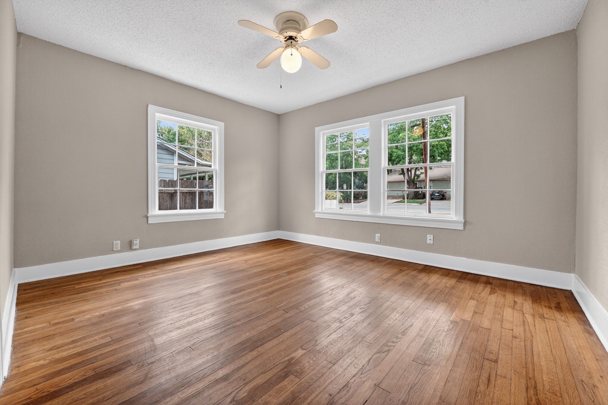 4907 Duval Street Austin, TX 78751 - Photo 17 of 31 a view of empty room with wooden floor and fan