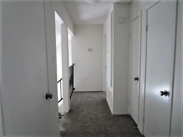 a view of a hallway with wooden door and entryway