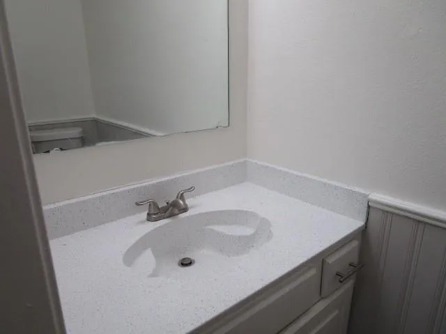 a bathroom with a sink and a white cabinet