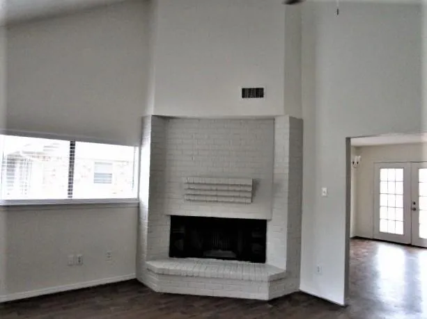 a living room with a fireplace and a window