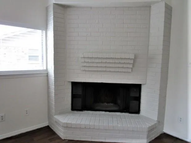 a living room with a fireplace and a window