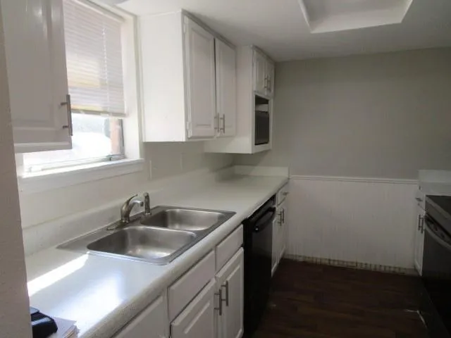 a kitchen with a sink and cabinets