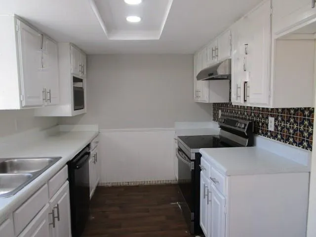 a kitchen with a sink and a stove top oven