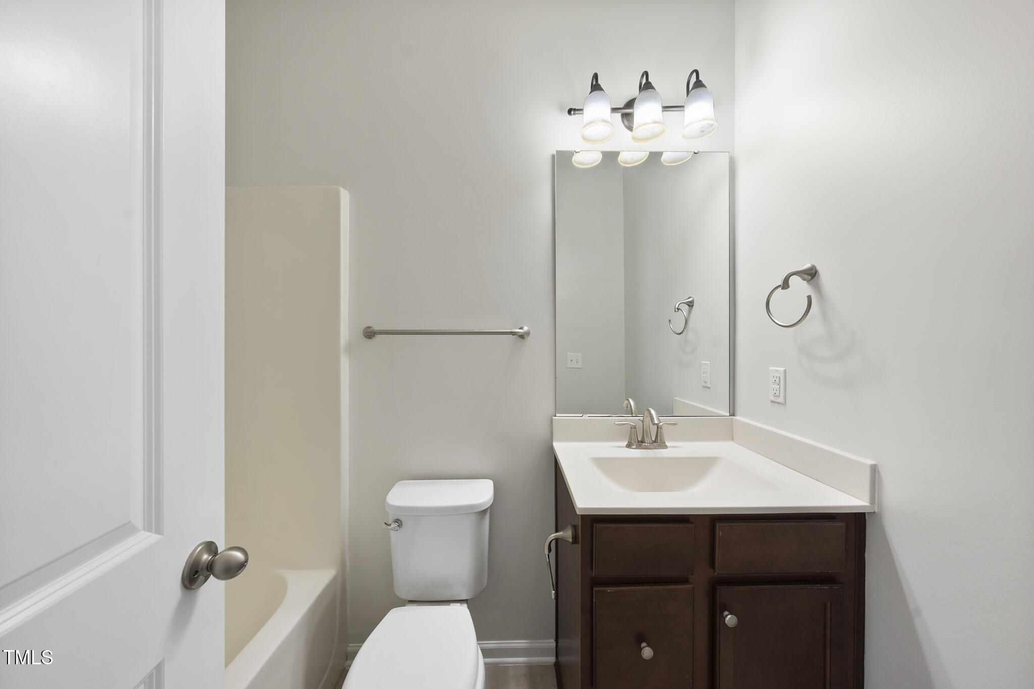 684 Wickham Ridge Road Apex, NC 27539 - Photo 12 of 18 a bathroom with a sink toilet and mirror