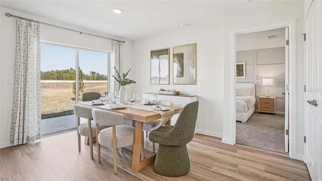 a view of a dining room with furniture window and wooden floor