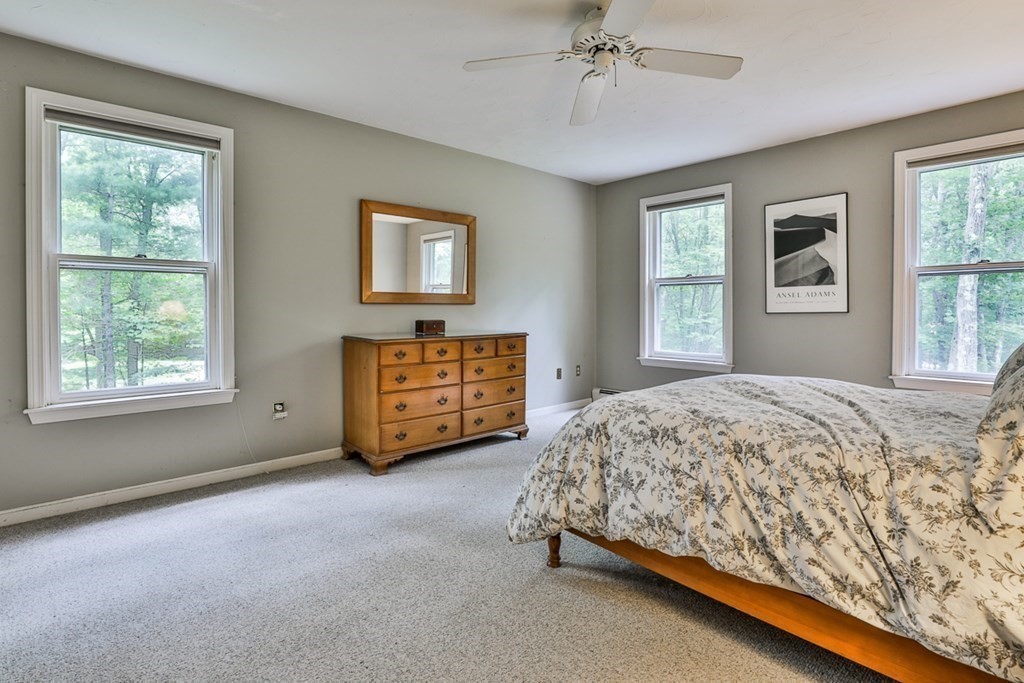 100 Stagecoach Road Lancaster, MA 01523 - Photo 15 of 29 a spacious bedroom with a bed windows and closet