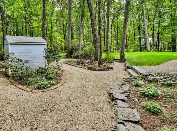 100 Stagecoach Road Lancaster, MA 01523 - Photo 27 of 29 a view of a backyard with plants and trees