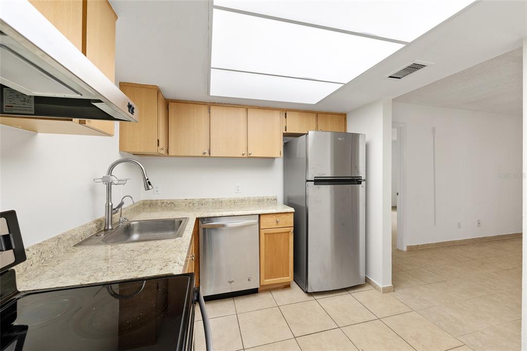 588 Fairways Lane, Unit E101 Ocala, FL 34472 - Photo 13 of 35 a kitchen with stainless steel appliances granite countertop a refrigerator sink and stove