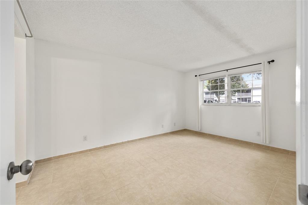 588 Fairways Lane, Unit E101 Ocala, FL 34472 - Photo 14 of 35 an empty room with a window