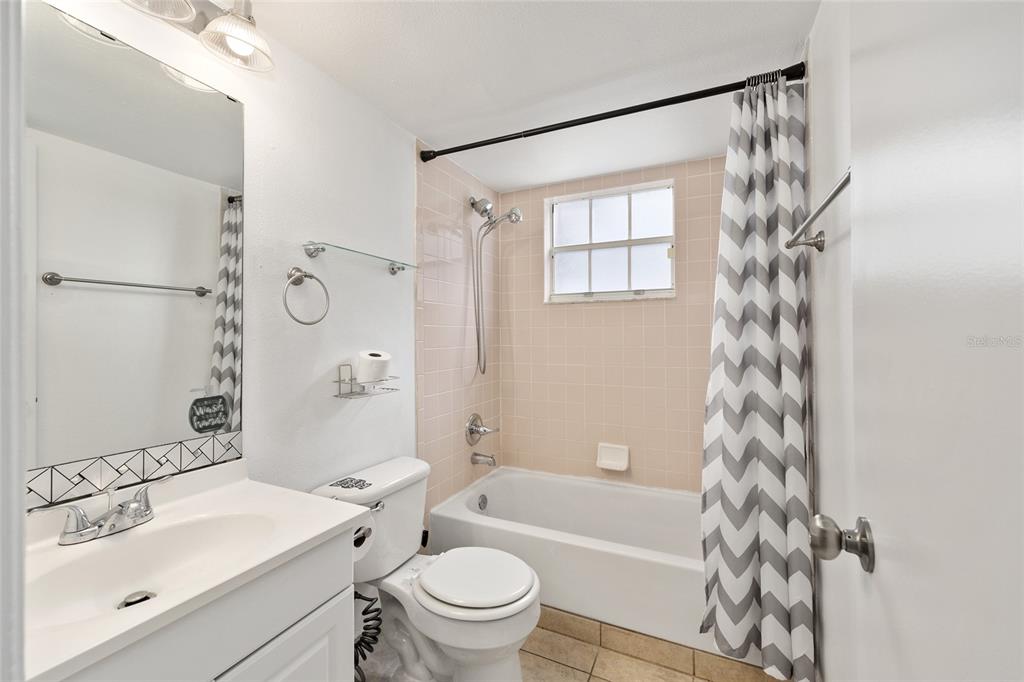 588 Fairways Lane, Unit E101 Ocala, FL 34472 - Photo 21 of 35 a bathroom with a sink a toilet a shower curtain and a bath tub