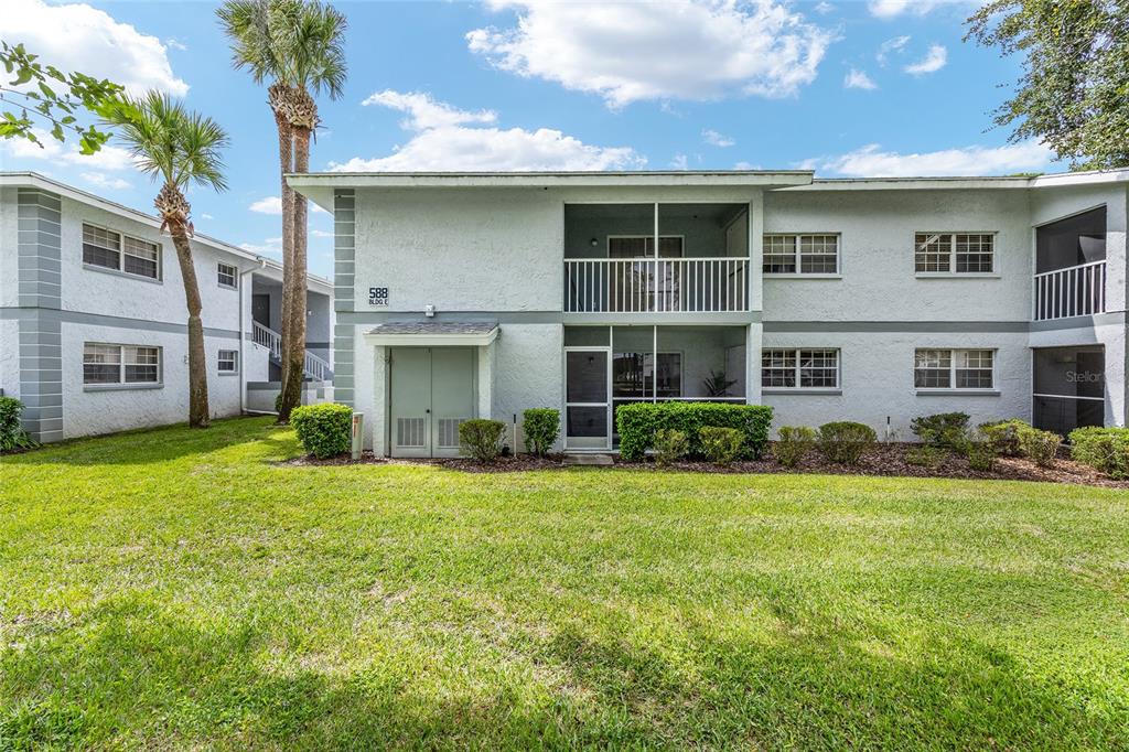 588 Fairways Lane, Unit E101 Ocala, FL 34472 - Photo 28 of 35 a front view of a house with a yard