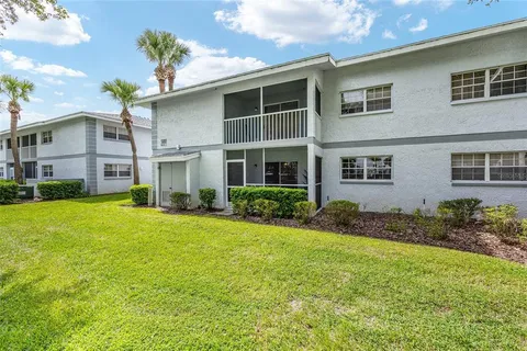 an aerial view of residential houses with outdoor space and swimming pool