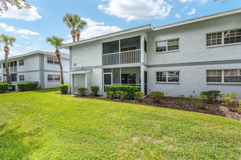 588 Fairways Lane, Unit E101 Ocala, FL 34472 - Photo 29 of 35 a front view of house with yard and trees around