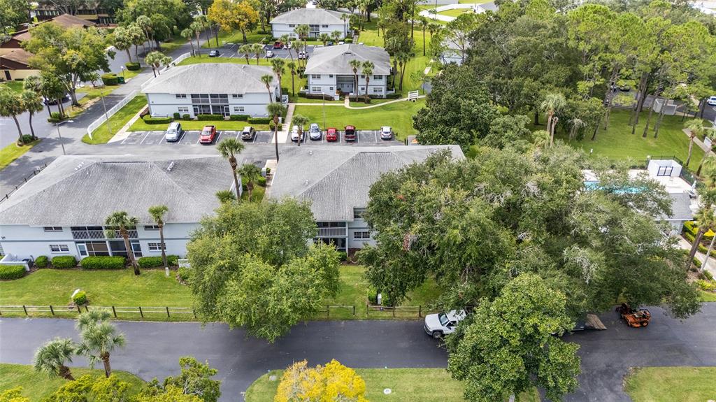 588 Fairways Lane, Unit E101 Ocala, FL 34472 - Photo 31 of 35 an aerial view of a house with swimming pool outdoor seating and yard