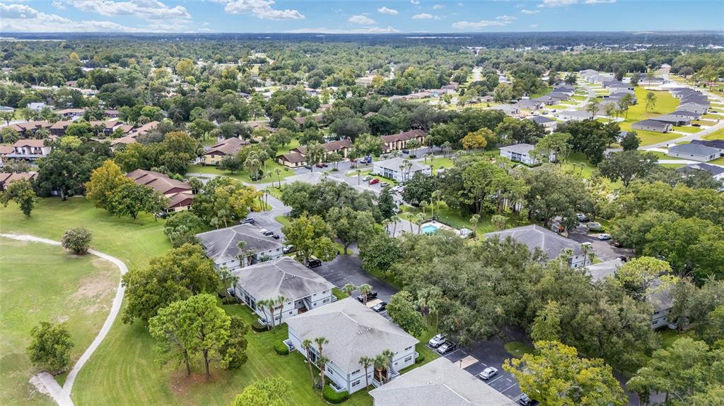 588 Fairways Lane, Unit E101 Ocala, FL 34472 - Photo 33 of 35 an aerial view of a house with a yard