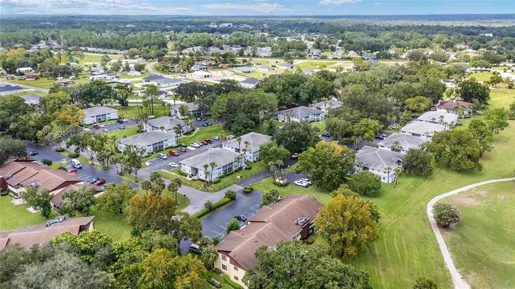 588 Fairways Lane, Unit E101 Ocala, FL 34472 - Photo 34 of 35 an aerial view of residential houses with outdoor space and trees