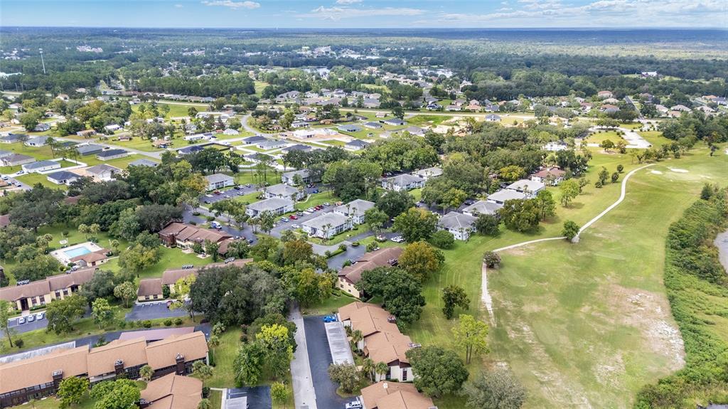 588 Fairways Lane, Unit E101 Ocala, FL 34472 - Photo 35 of 35 an aerial view of residential house with parking and city view