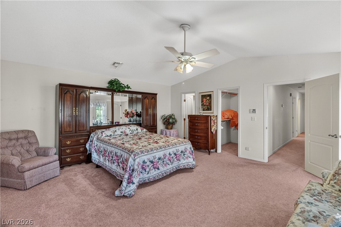 2055 Cholla Way Laughlin, NV 89029 - Photo 29 of 87 A spacious bedroom features plush carpeting and a soaring vaulted ceiling.