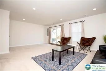 a living room with furniture and a rug