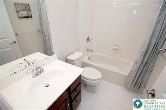 a bathroom with a sink a toilet and bathtub
