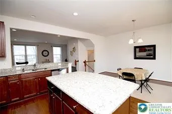 a kitchen with a sink a stove and chairs