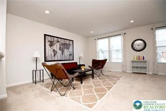 a living room with furniture a clock and a large window