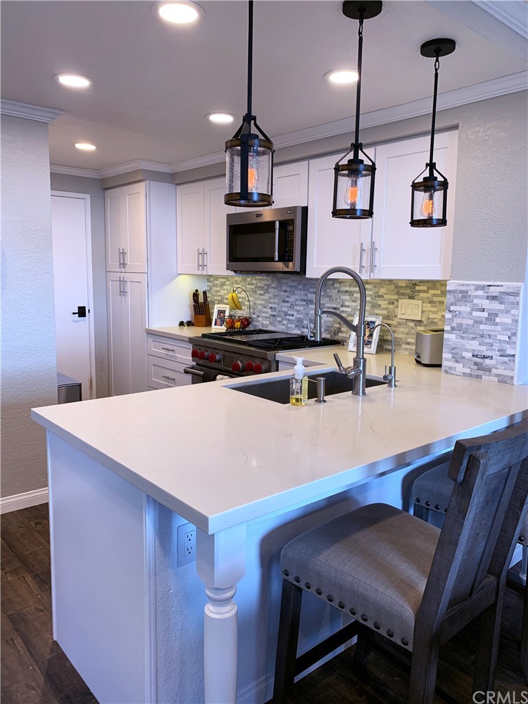 Perfectly appointed with custom backsplash, breakfast bar, Wolf range and Sub Zero fridge, means cooking for your family and friends in this exquisite kitchen is pure joy.