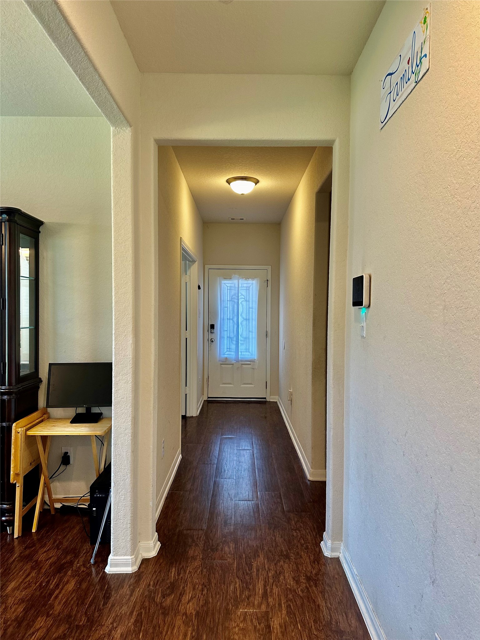 18622 Each Elm Way Houston, TX 77084 - Photo 9 of 35 a view of a hallway with wooden floor and a bathroom