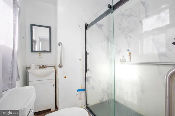 a bathroom with a sink toilet and shower