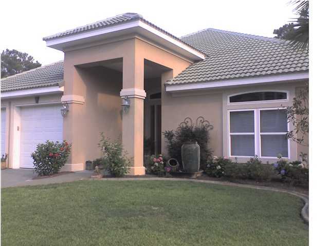 110 Indigo Loop Miramar Beach, FL 32550 - Photo 1 of 15 a front view of a house with garden