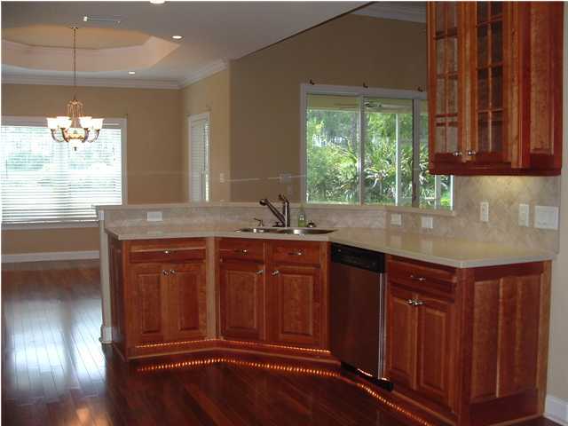 110 Indigo Loop Miramar Beach, FL 32550 - Photo 4 of 15 a kitchen with granite countertop wooden cabinets a sink and dishwasher