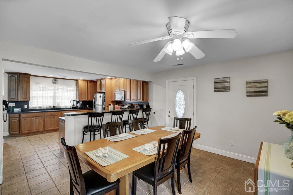 11 Kenmore Road Edison, NJ 08817 - Photo 11 of 40 a dining room with a table chairs and a kitchen view
