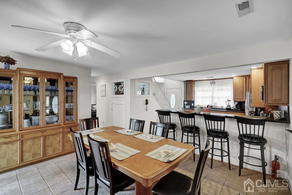 11 Kenmore Road Edison, NJ 08817 - Photo 12 of 40 a view of a dining room with furniture and chandelier