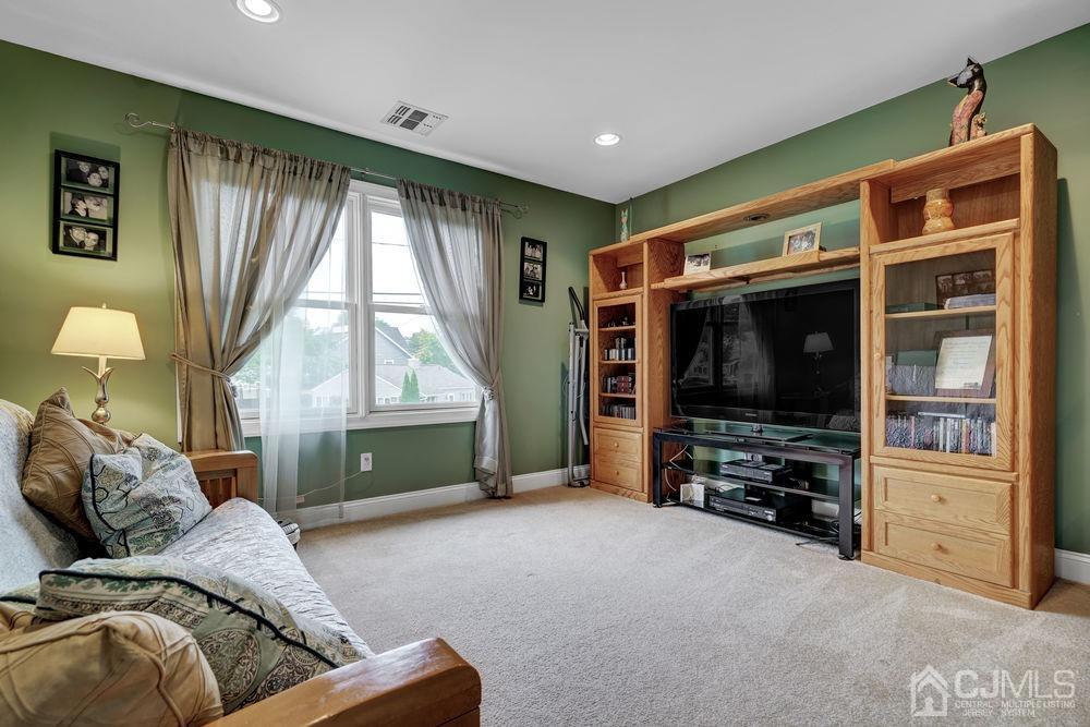 11 Kenmore Road Edison, NJ 08817 - Photo 23 of 40 a living room with furniture and a flat screen tv