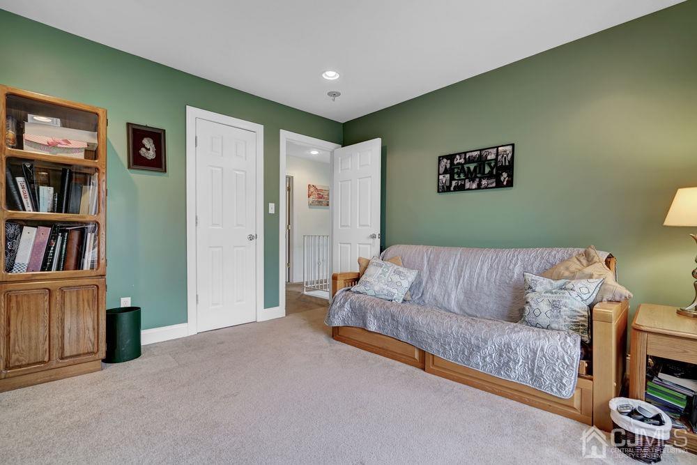 11 Kenmore Road Edison, NJ 08817 - Photo 24 of 40 a living room with furniture and a book shelf