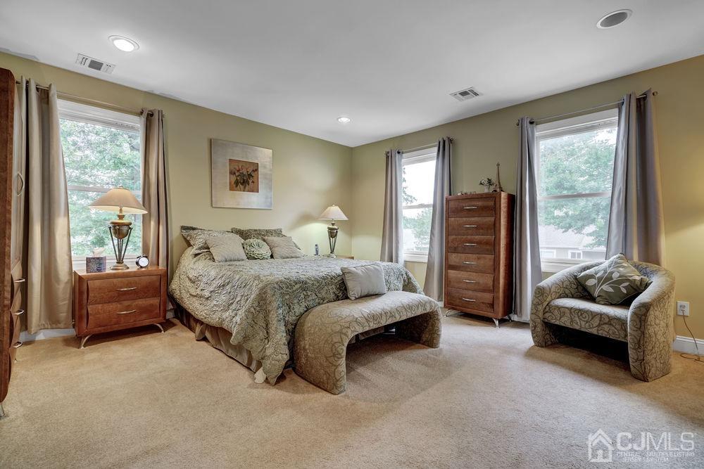 11 Kenmore Road Edison, NJ 08817 - Photo 25 of 40 a bedroom with a bed and a couch