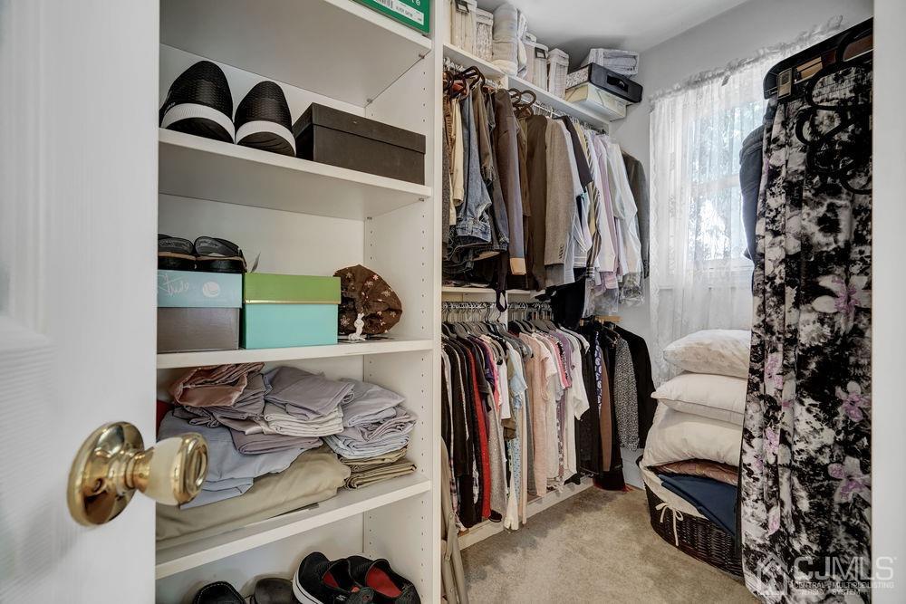 11 Kenmore Road Edison, NJ 08817 - Photo 27 of 40 a view of walk in closet with clothes and shoes
